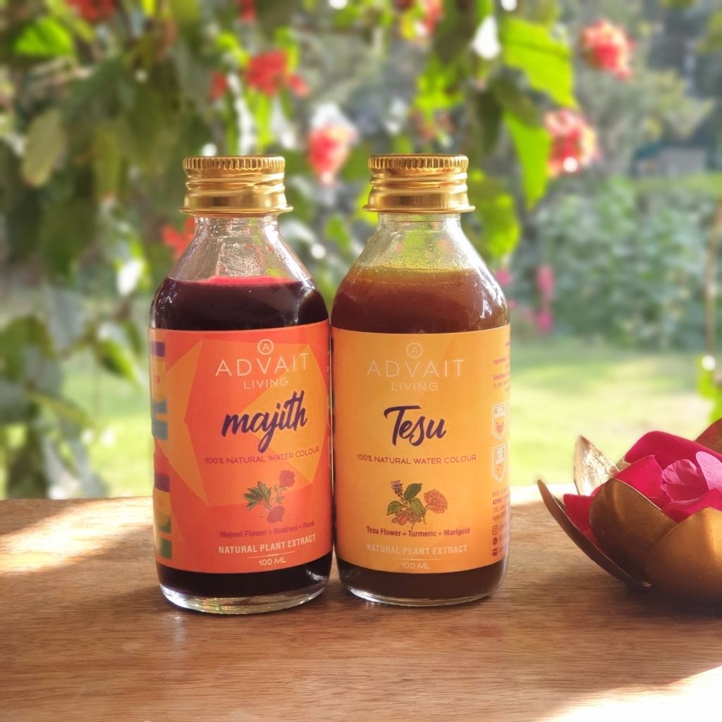 holi water colours: Two bottles majith and tesu on wooden table with sun