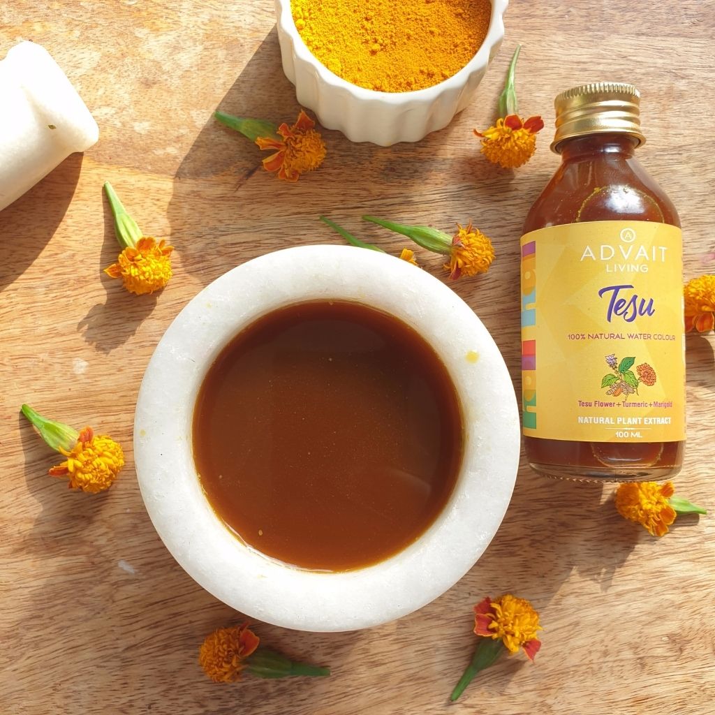 A bottle and bowl containing tesu water colour on a table