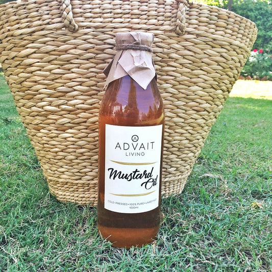 Cold Pressed Mustard Oil 1 Litre glass bottle standing on grass