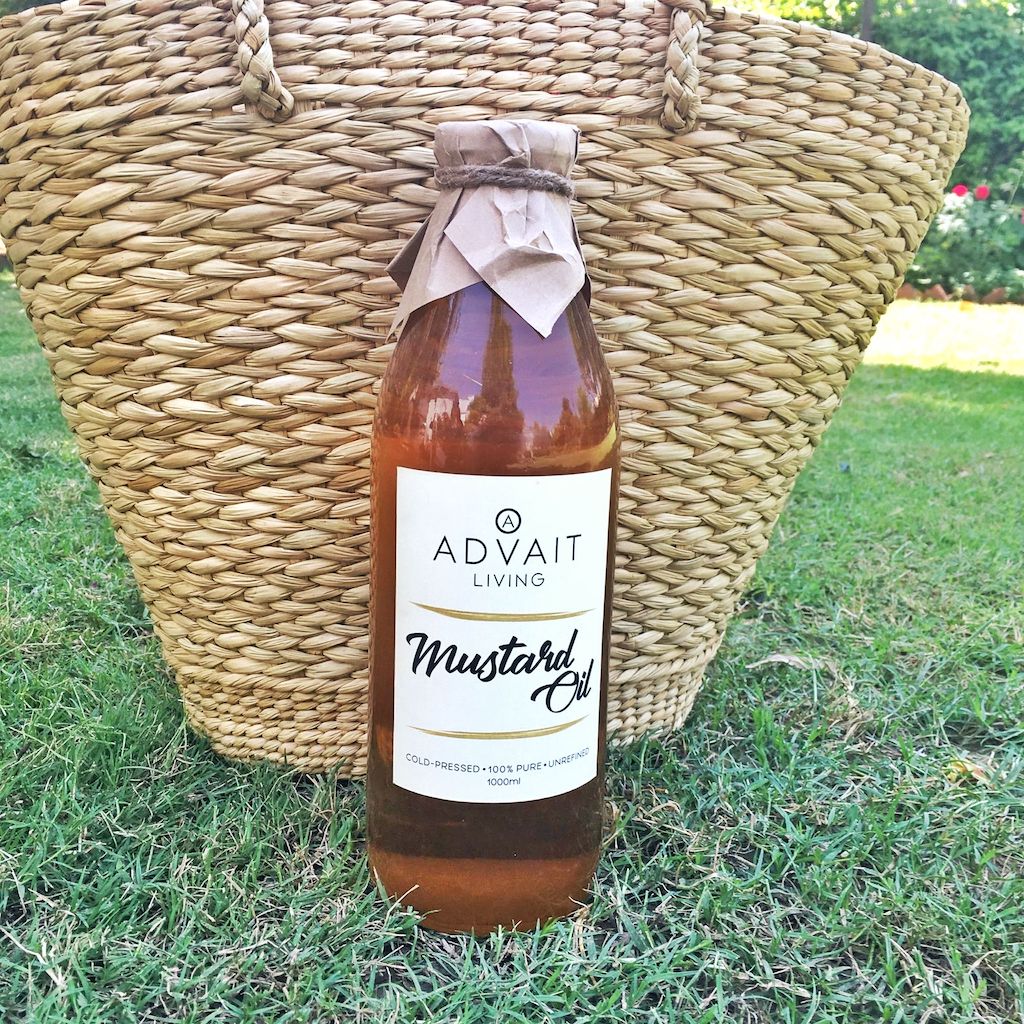 mustard oil 1 Litre glass bottle standing on grass
