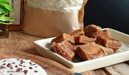 Advait Living Organic Jaggery Cubes placed on a white plate.