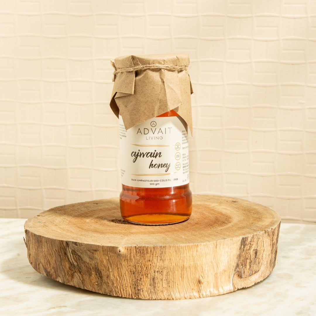 500 gm glass bottle of Advait Living Raw Ajwain Honey
