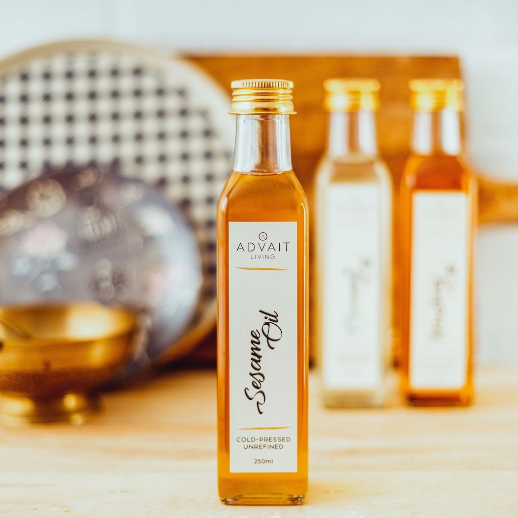 250 ml Advait Living Cold-pressed Sesame Oil in a glass bottle